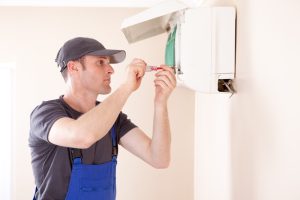 HVAC-technician-working-on-a-ductless-mini-split-air-handler